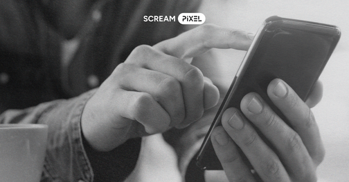 Black-and-white photo of a person using a smartphone, with bold overlay text reading ‘Mobile-First Design’ and ‘Why it’s crucial in today’s digital world,’ and a small ‘Scream Pixel’ logo at the top.